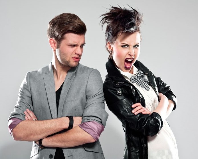 A well-dressed man looking at a "punk" woman in disgust