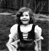 Young Jones smiling at the camera outside
