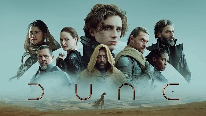 'Dune' poster with Timothée Chalamet's Paul in the center surrounded by the other characters against a blue sky over the desert with the text 'Dune'