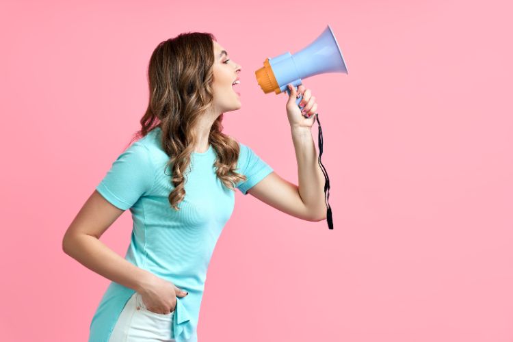 Woman promoting herself into a megaphone.