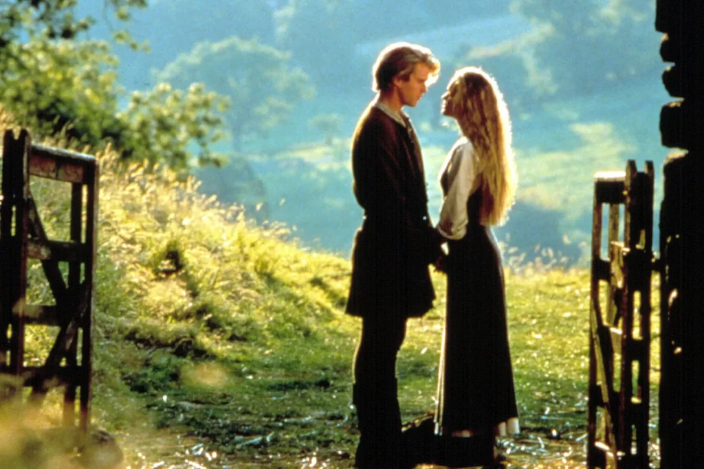 Buttercup and Westley standing close with Butter holding his wrists