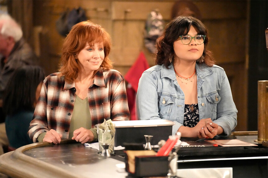 Reba McEntire and Belissa Escobedo stare and something out of sight of the camera.