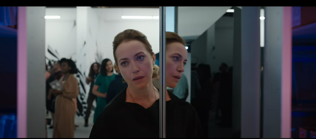 Still frame from the Candyman trailer, showing the art critic (played by Rebecca Spence) interacting with the work created by Anthony McCoy.