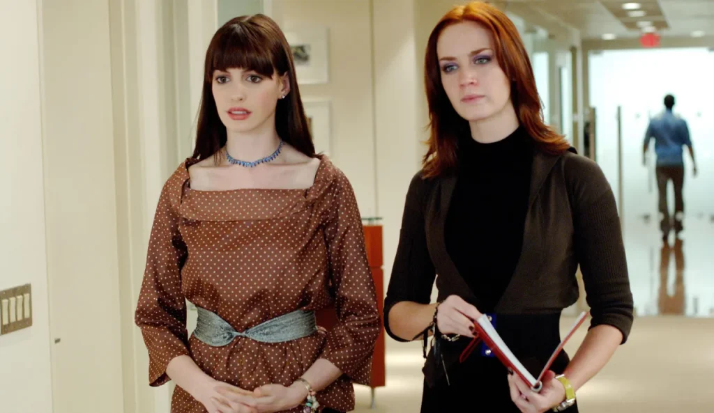 Andy (played by Anne Hathaway) and Emily (played by Emily Blunt) from The Devil Wears Prada standing next to each other.