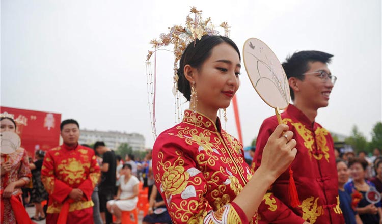 A crowd of people wearing formal clothes for the Qixi Festival.