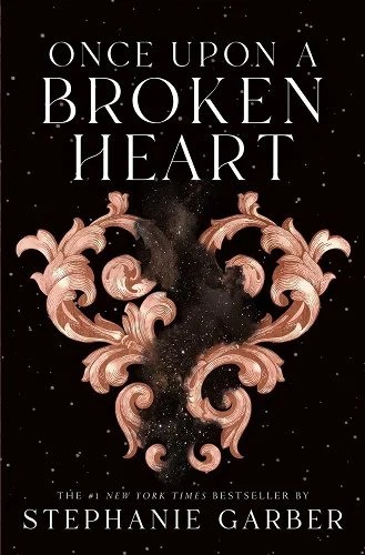 The book cover of Once Upon A Broken Heart by Stephanie Garber. Ornate vines form a heart, with sparkly black mist in between, on a black background full of dotted light.