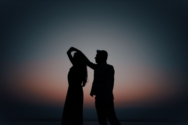 There are two shadows of a man and a woman dancing.