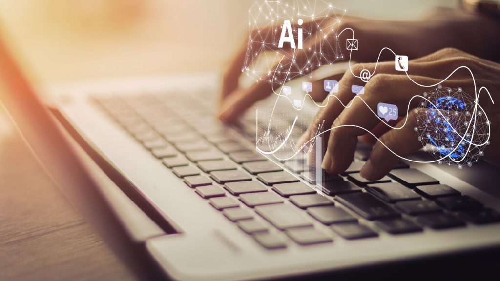 Hands typing on a laptop keyboard. Technological strings are over the hands, as well as the word "Ai."