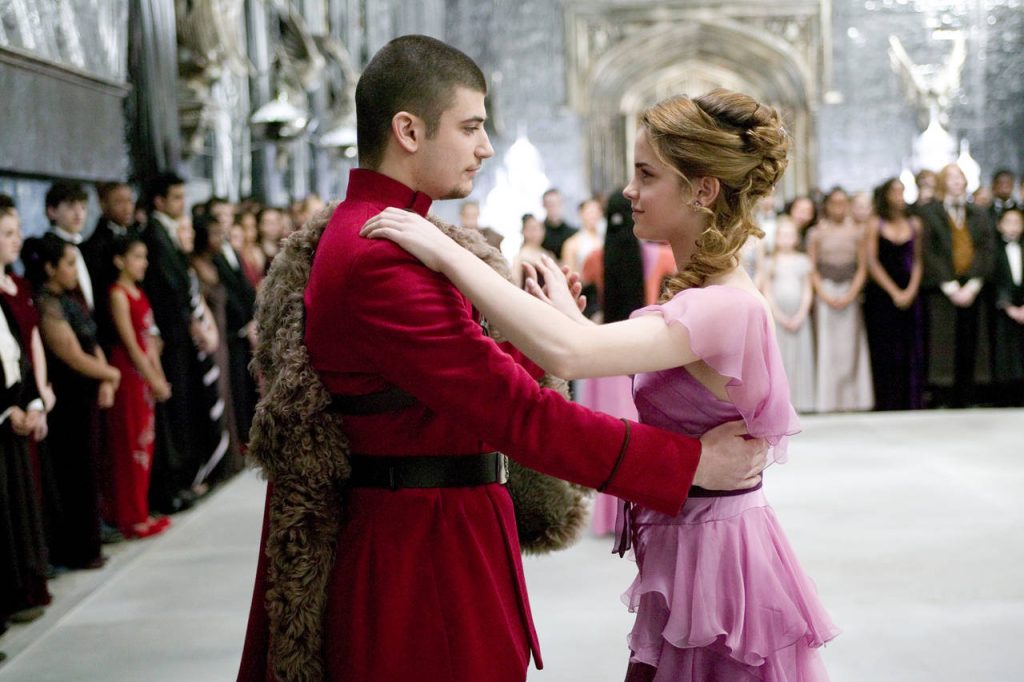 Movie still of Hermione dancing with Viktor Krum. Other students are in the background, but the pair only has eyes for each other.