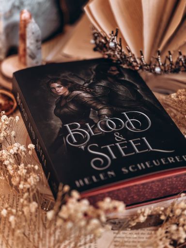 Image provided by Bookstagrammer Steph of the book "Blood and Steel by Helen Scheuerer. Its pages are dyed in red as well as the hard cover.