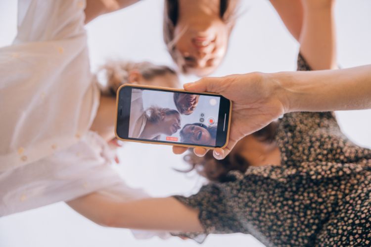 Three girls are taking a photo of themselves.