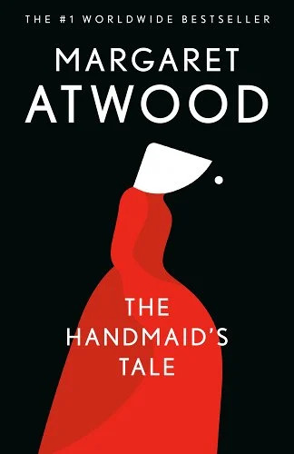 Black cover depicting a woman in a red dress with a white hood.