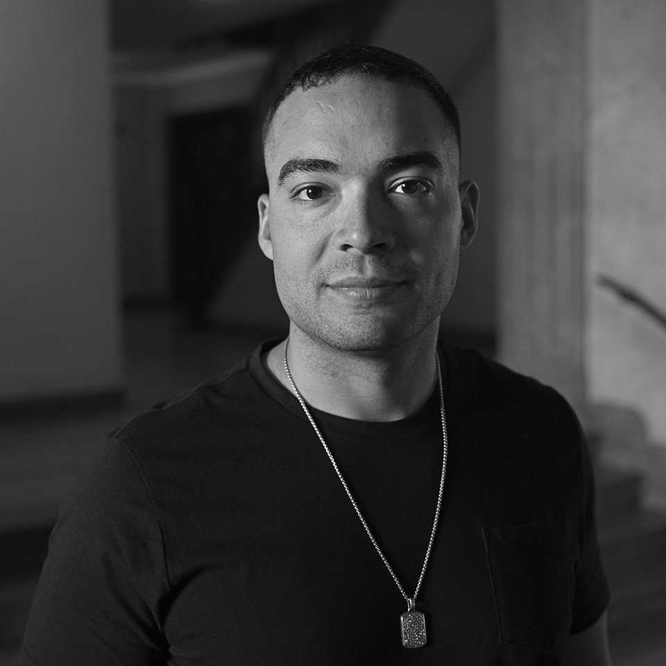 Black and white photo of Andrew Boryga slightly smiling.