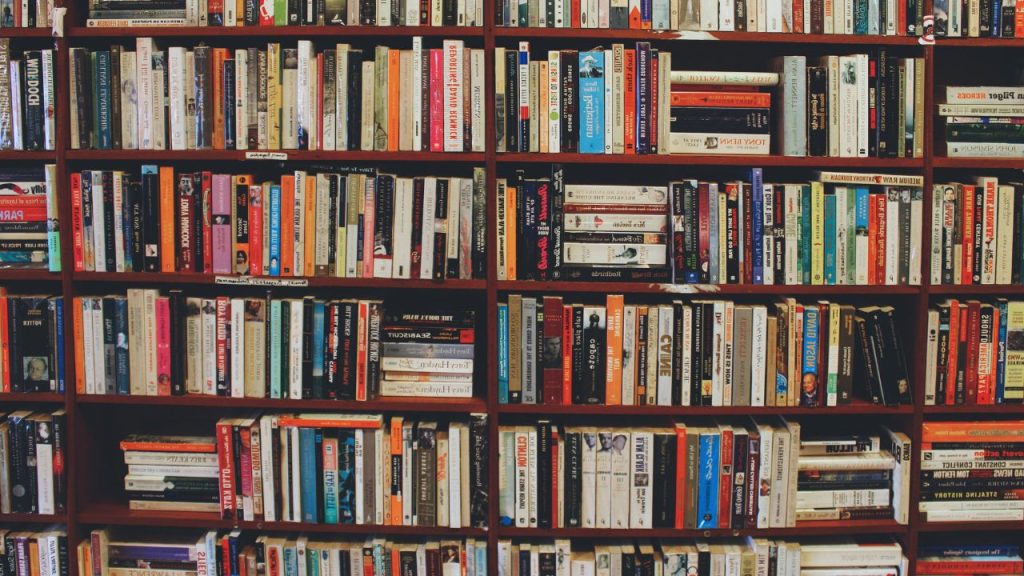 Bookshelves with books messily filling bookshelves.