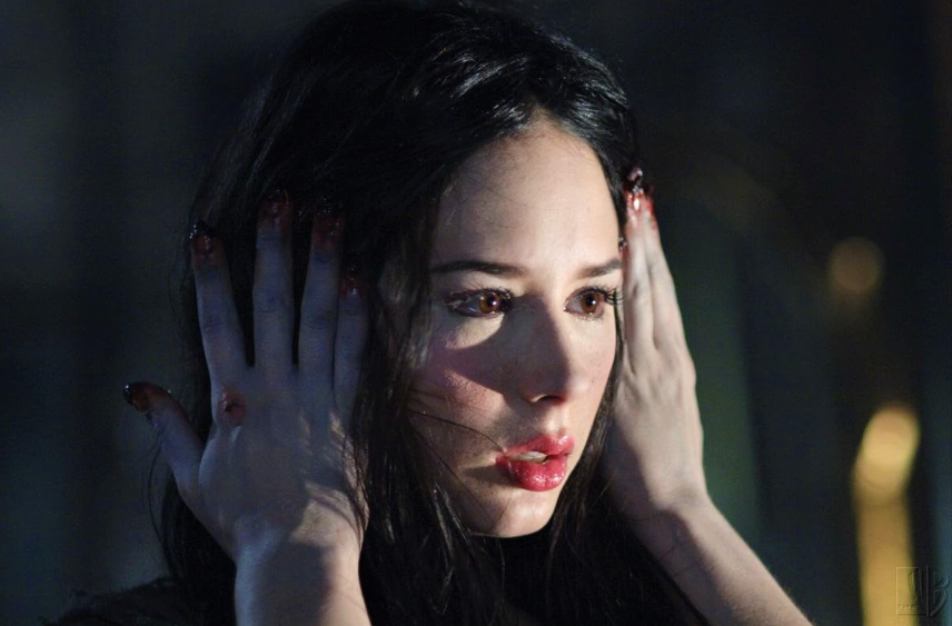 Still from Supernatural of a woman with hands over her ears, her fingernails are missing.
