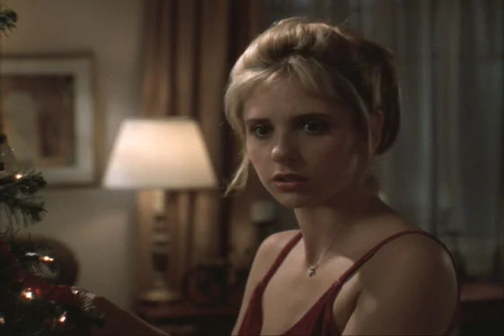 "Buffy the Vampire Slayer" TV scene of Buffy staring in alarm in front of a Christmas tree.