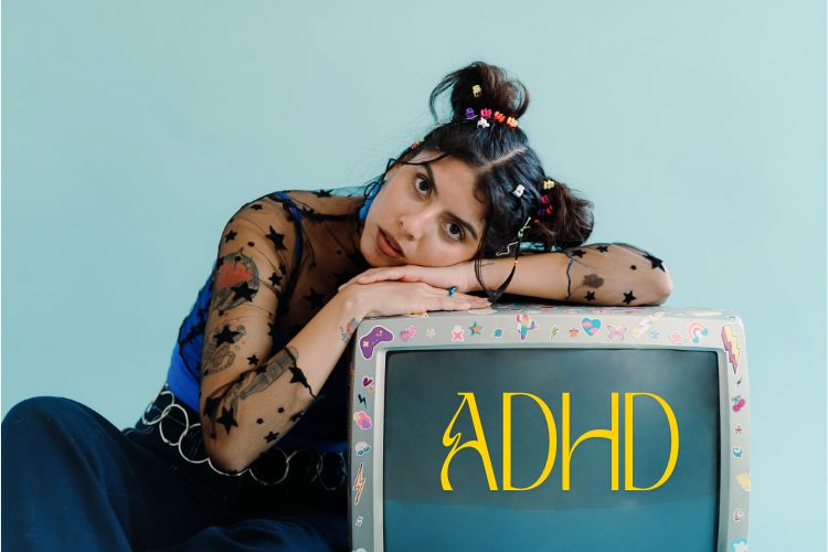 Girl leaning onto a TV with colorful stickers on it. TV has words on it: ADHD