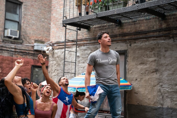 Image of a group of people cheering in an alley way.