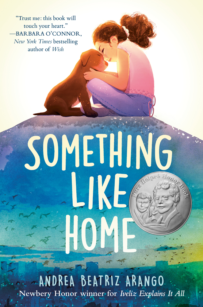 A young girl sitting cross-legged, tenderly embracing a brown puppy. The backdrop features a soothing blue and green gradient sky with birds in flight and gentle waves. The title is in large white font, and the Pura Belpré Honor Award medal is displayed, signaling the book's recognition for its cultural contribution.