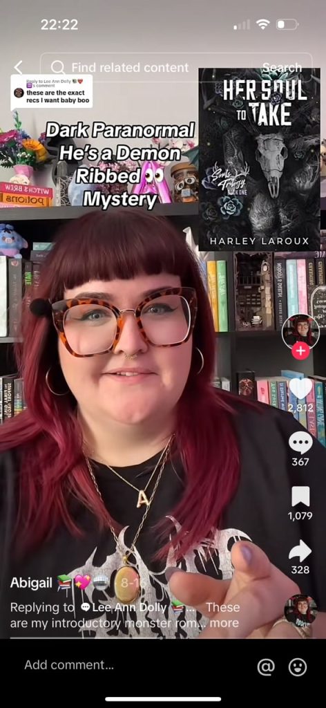 A tiktok video of @abigailreadzz recommending Her Soul to Take, the cover of which is filled with dark flowers and a skull, with minimal color.