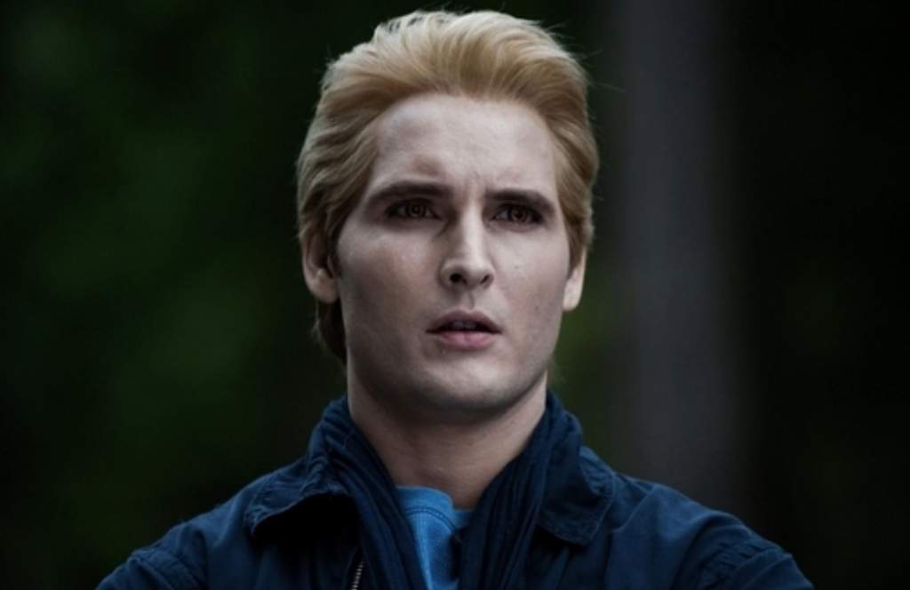 Carlisle Cullen staring at something offscreen in the woods.