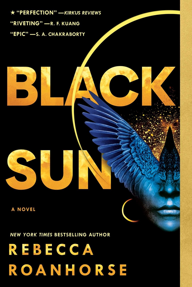 The large gold text reads "Black Sun" over a black background and an image of half of a dark human face concealed by one of a half-visible blue crow's wings. A gold outline surrounds the face and wings, and a small gold moon is to the left of the face. Below the image is a yellow text that reads "New York Times Bestselling Author," as well as gold text that reads "Rebecca Roanhorse."