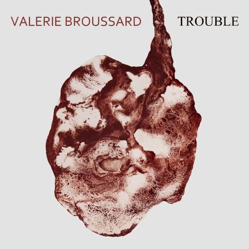 Trouble by Valerie Broussard single cover. A dark red paint spill in the shape of an anatomically accurate heart flows over a light grey background. Above the heart, red text reads "Valerie Broussard", followed by black text that reads "Trouble".