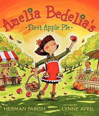 The cover of *"Amelia Bedelia's First Apple Pie"* features bright colors such as red, orange, and green. In the background, there are several apple trees with ripe apples, along with market stalls displaying various fruits and vegetables. Amelia Bedelia, wearing an apron is holding a basket of apples and holding one in the air.