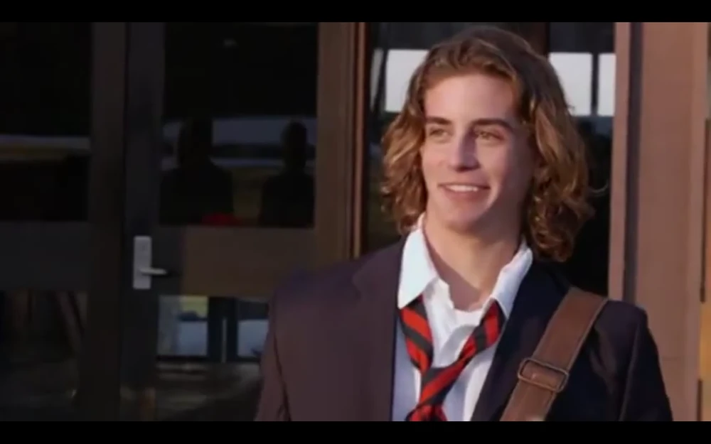 Chris Abeley looking off to the side and smiling.