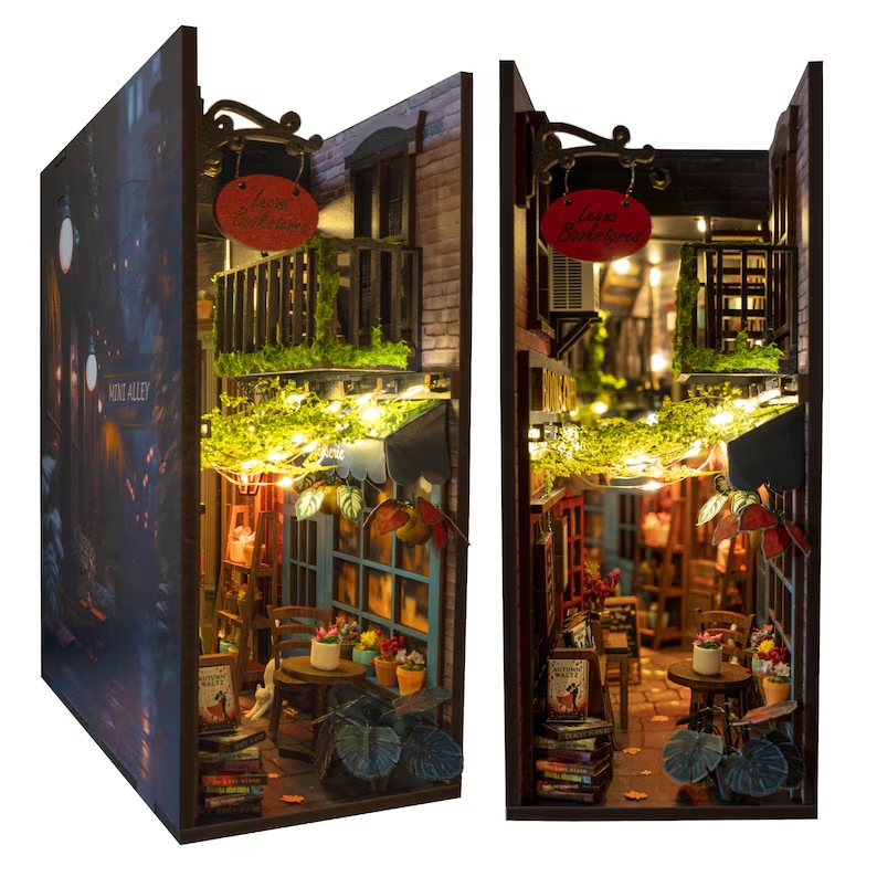 A rectangular box is shown that has been turned into a mini alley with lights, balconies and books.