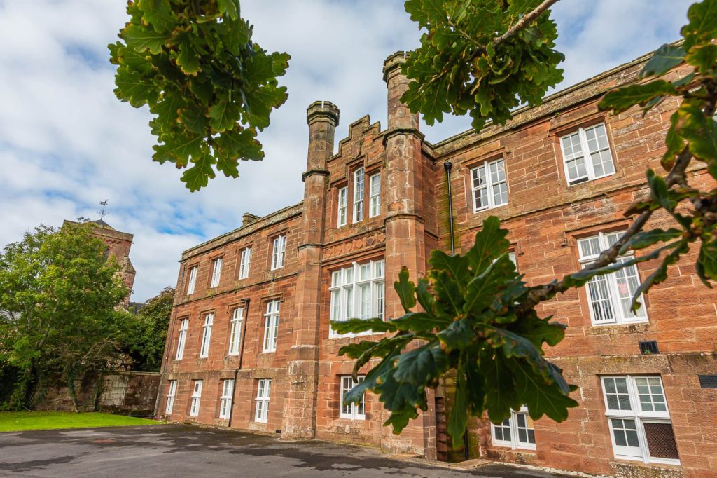 St Bees School which Leonard Ewbanks attended from 1902 to 1911. The school is brick-built and looks like a college with another connected building to its right.