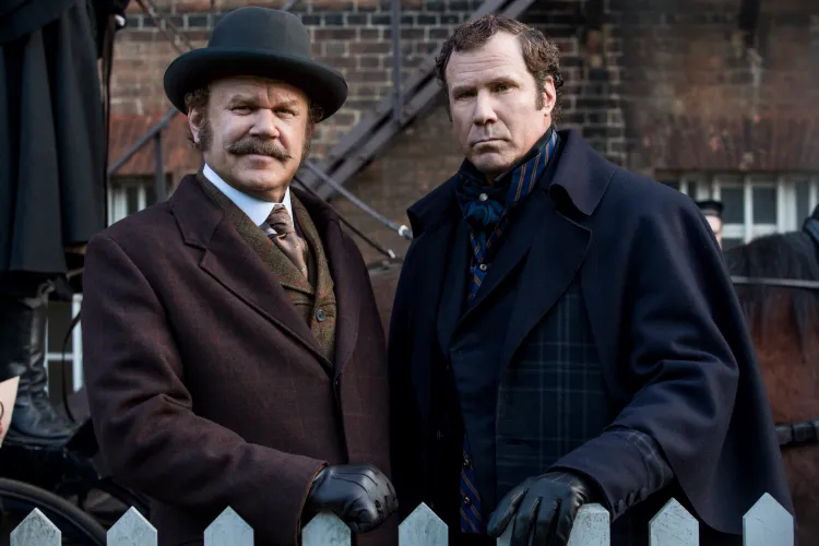 Sherlock and John from 'Holmes and Watson' facing the camera and resting their hands on a picket fence