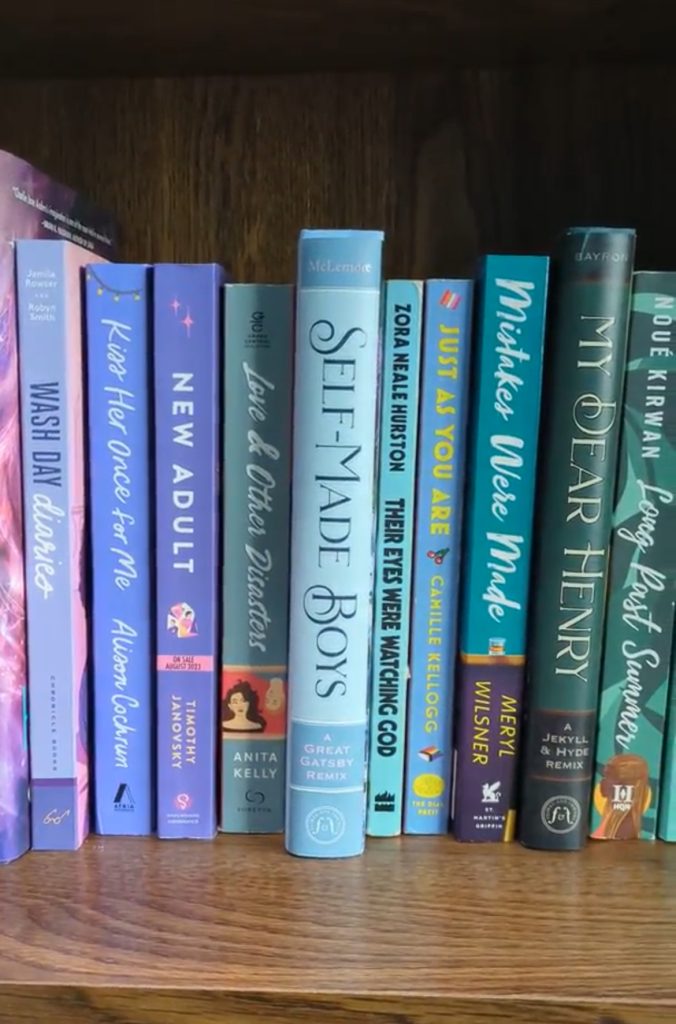 Set of blue vertically stacked books from TJ Alexanders bookshelf