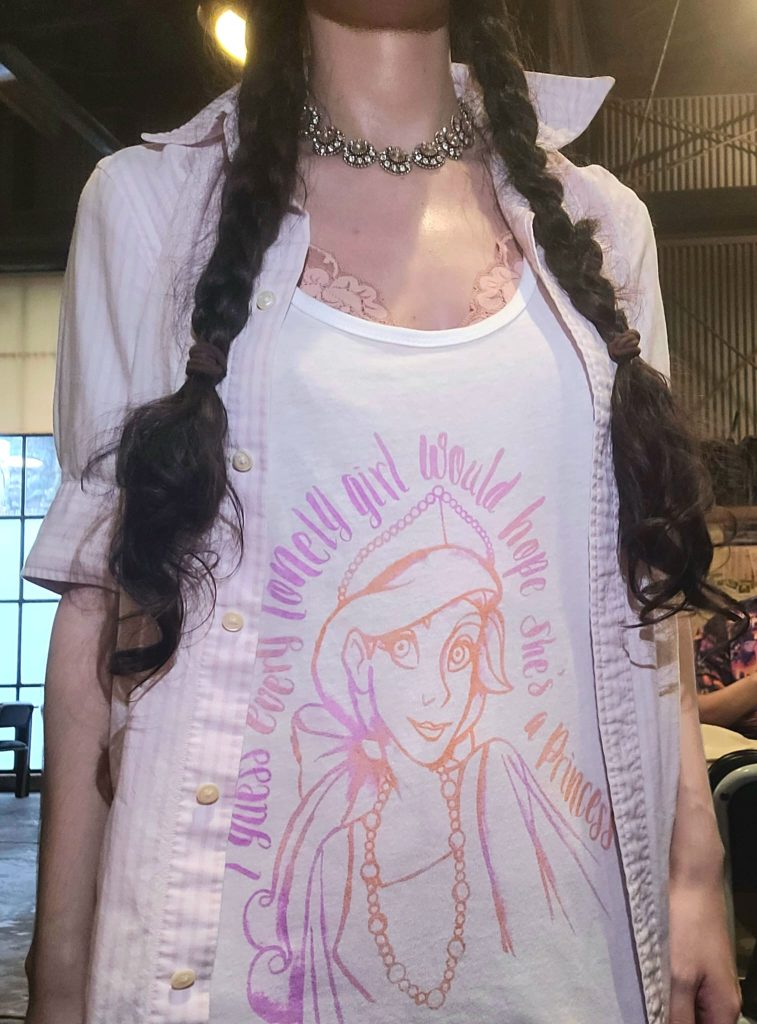 Girl in braids wearing Anastasia graphic tank top paired with an open button-down and a rhinestone choker.