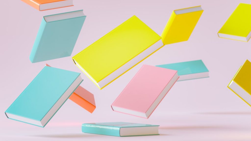 Several pastel-colored books fly across a light pink background.