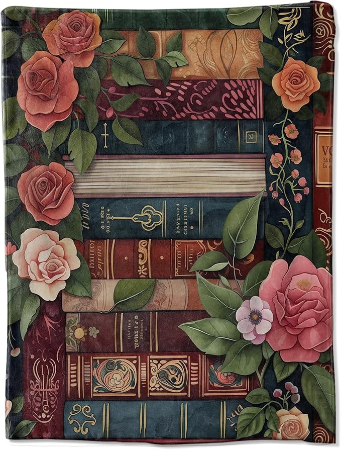 Throw blanket with pink flowers along the edge and a stack of vintage books in the center.