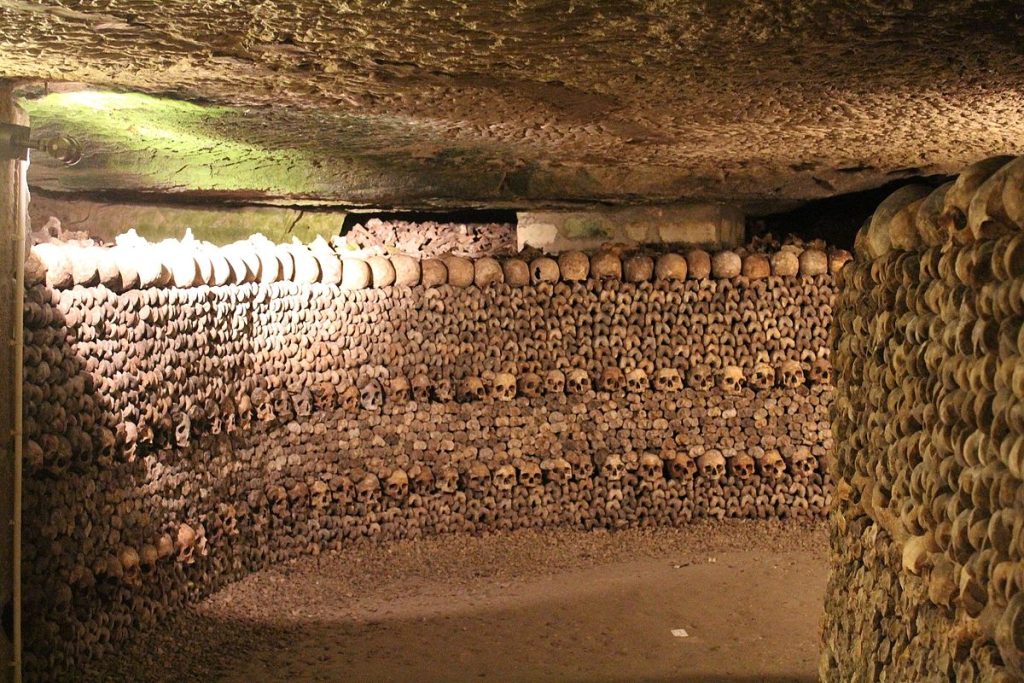 A tunnel with wall-to-wall skulls layered on top of each other.
