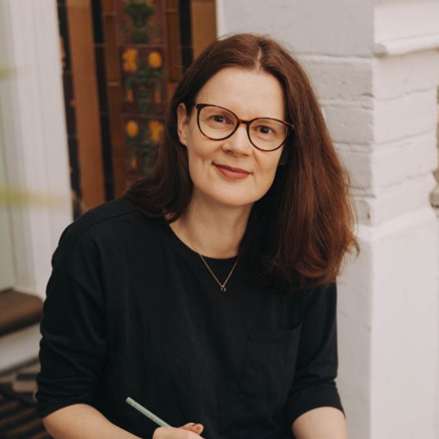 Evgenia Penman sitting on her front steps with pen and notebook