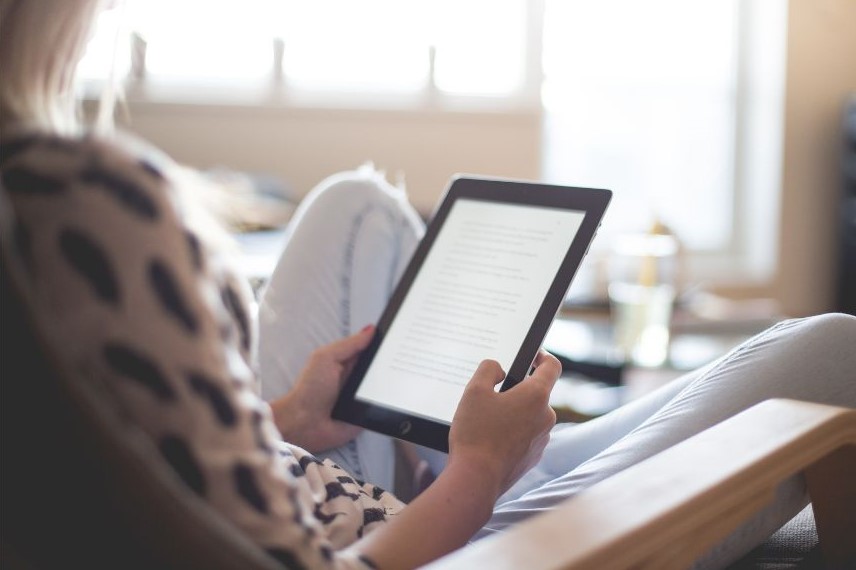 Someone reading on a Kindle