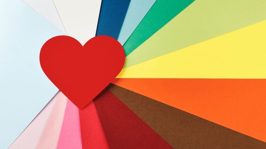 A heart with rainbow streaks extending out from it.