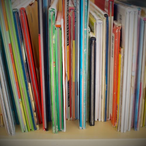 Zoom in on a bookshelf filled with different children's books, vignette filter shadowing the corners.