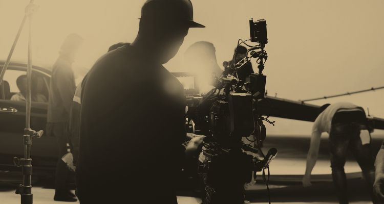 Production crew work to set up a scene for filming.