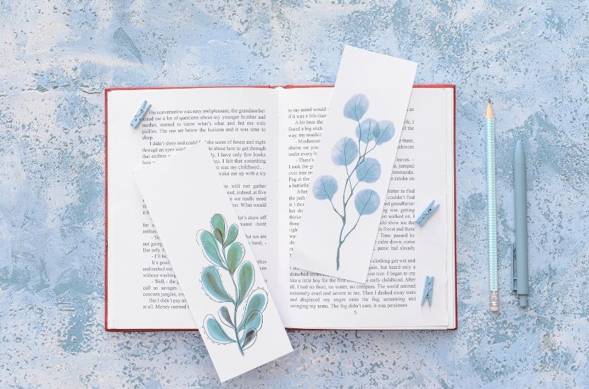 Two bookmarks resting on the pages of an open book
