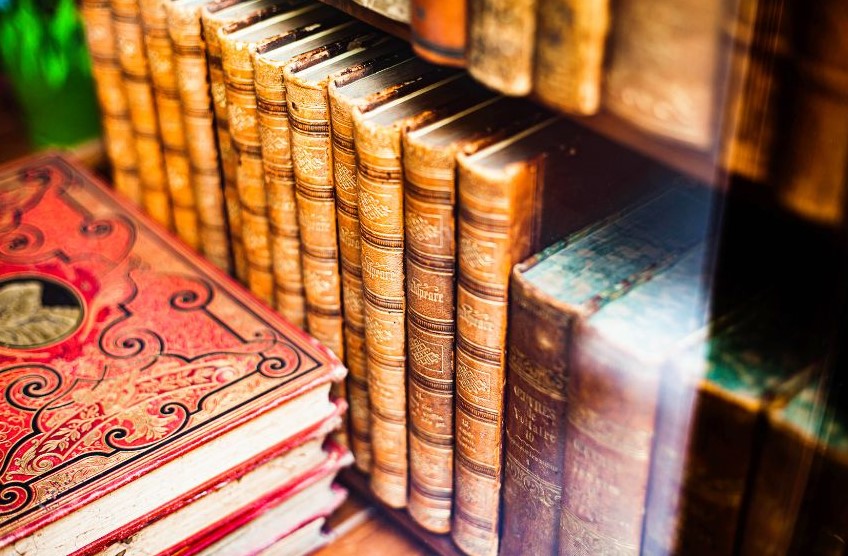 Hardcover books neatly stacked in shelves and on tables