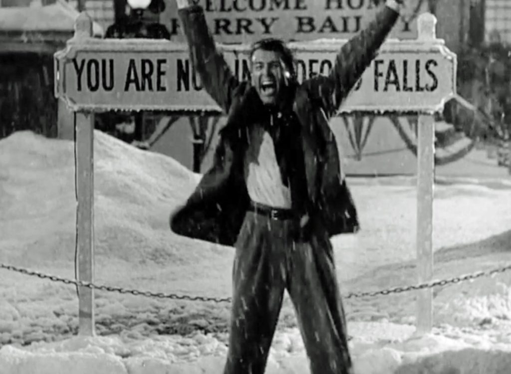 George Bailey running with his arms raised in the snow