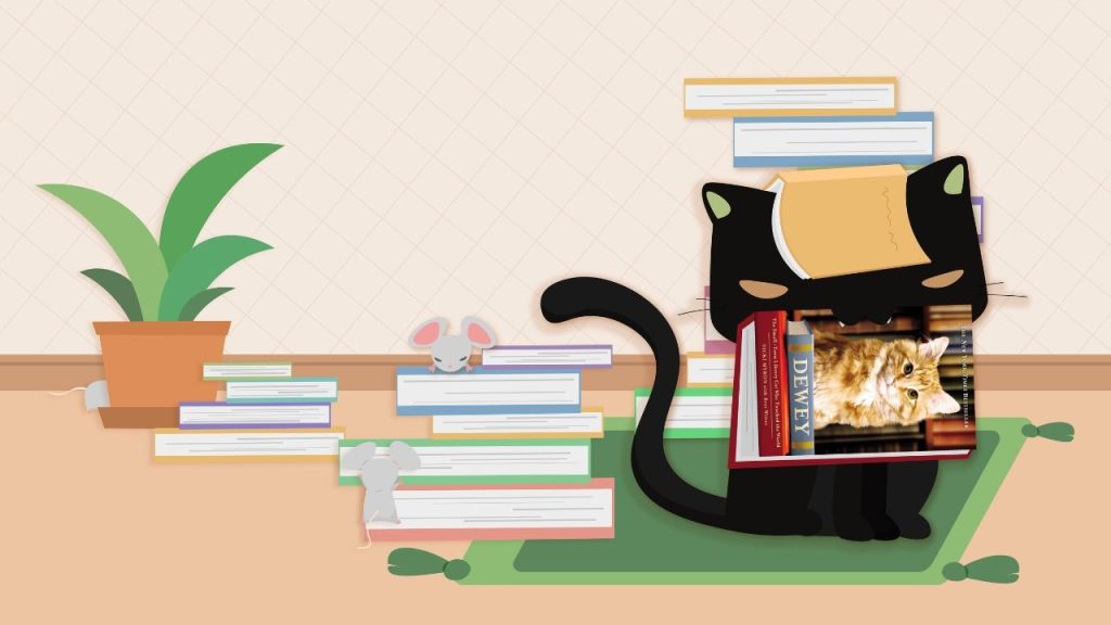 Paws on Pages: The Truth About Library Cats by Gabriela Collazo. It shows a black cat with a book in its mouth, a book on its head. He's standing on a table with more stacks of books, some mice, and a potted plant.