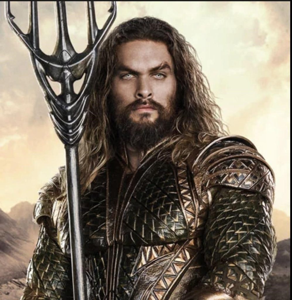 Picture of the character Aquaman wearing black and gold armor. And he's holding a gold trident.