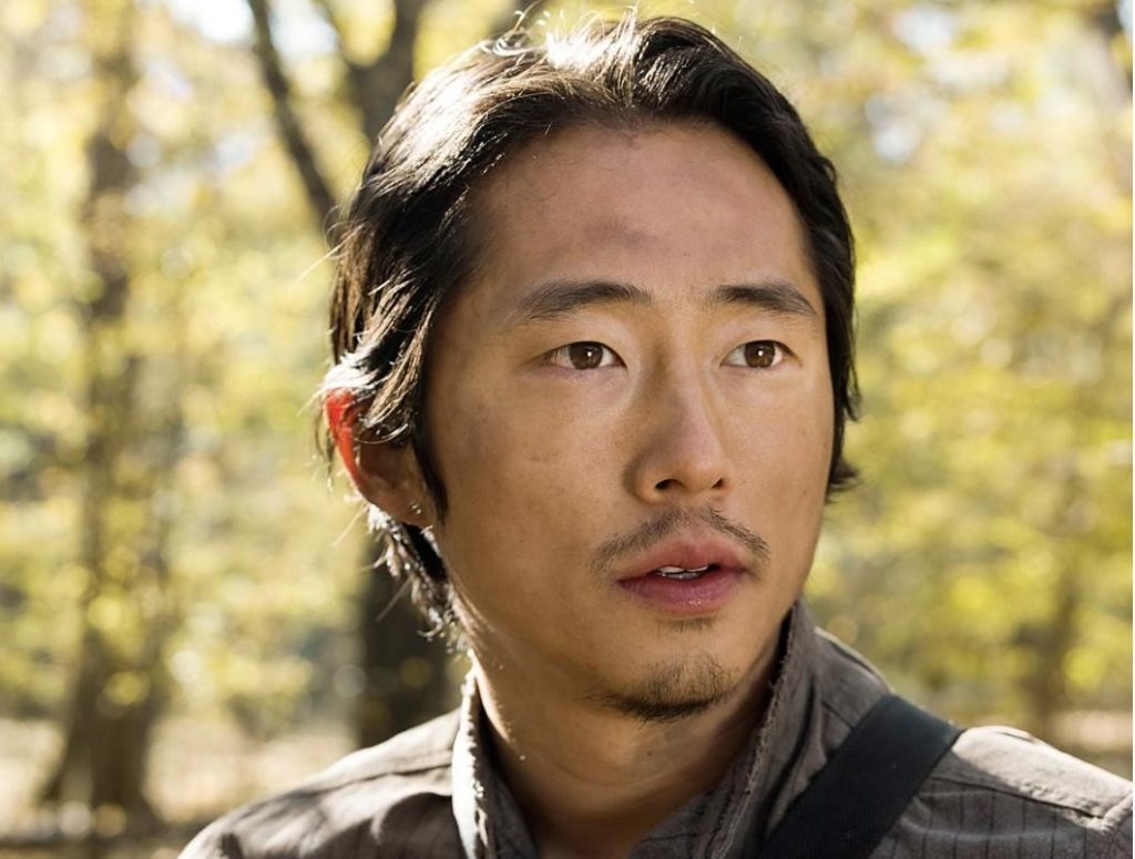 Picture of character Glenn Rhee wearing a gray striped shirt in the show, The Walking Dead.