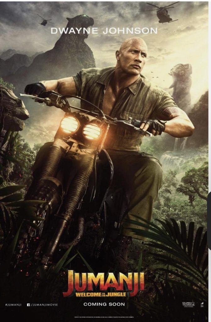 Picture of Dwayne Johnson riding a motorcycle in a jungle background in the movie Jumanji.