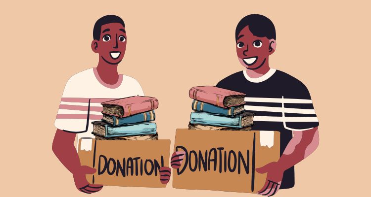 Two people holding boxes that say "Donation" with books piled inside of them.